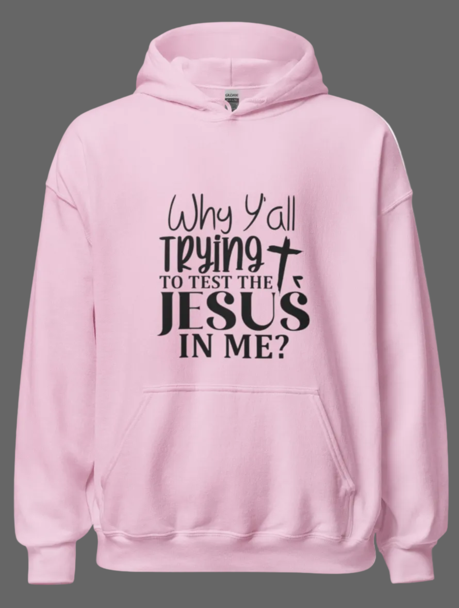 Light pink unisex Christian hoodie by MotherMindset featuring the "Why Y'all Trying to Test Jesus in Me" slogan on the front.